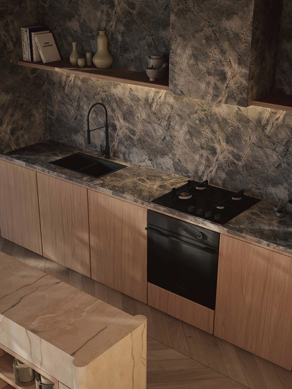 Kitchen worktop in dark veined quartzite with an integrated hob, black oven, and open shelving styled with books and ceramics.