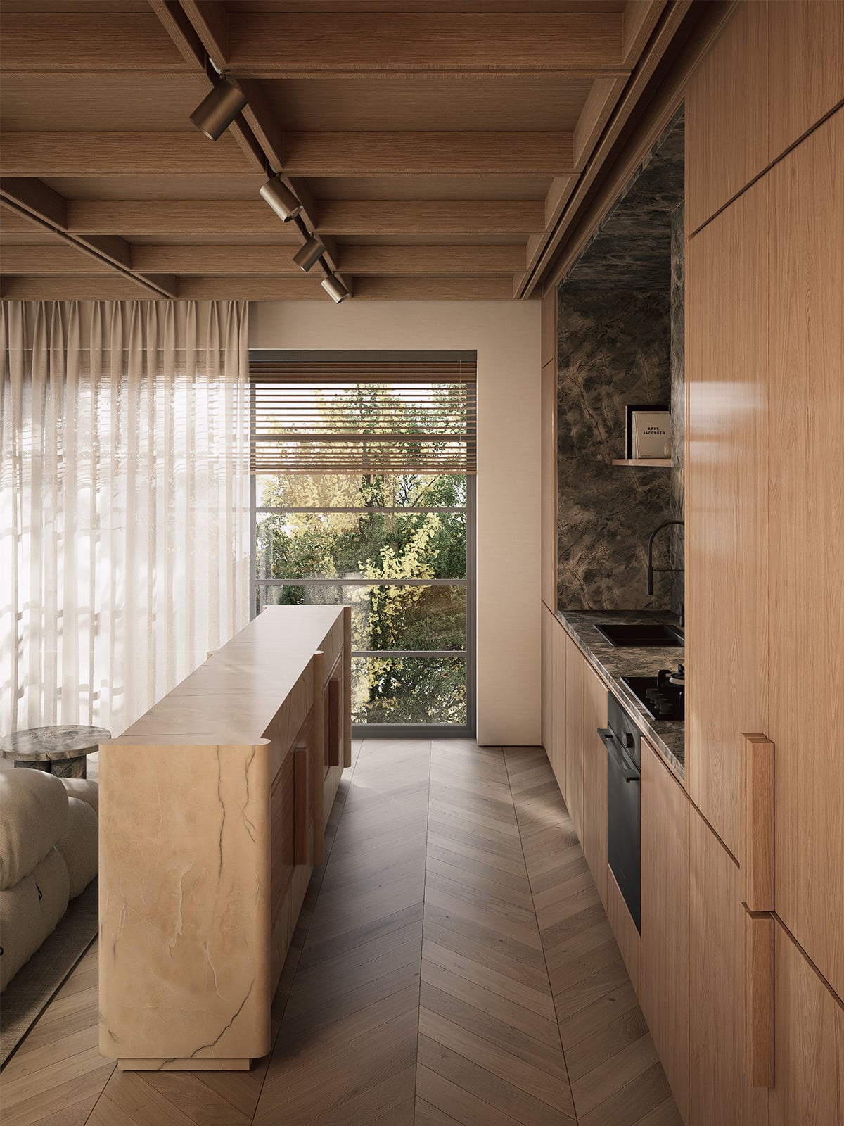 Kitchen island in warm marble stretching toward a tall window, with the dark stone kitchen backsplash visible to the right.