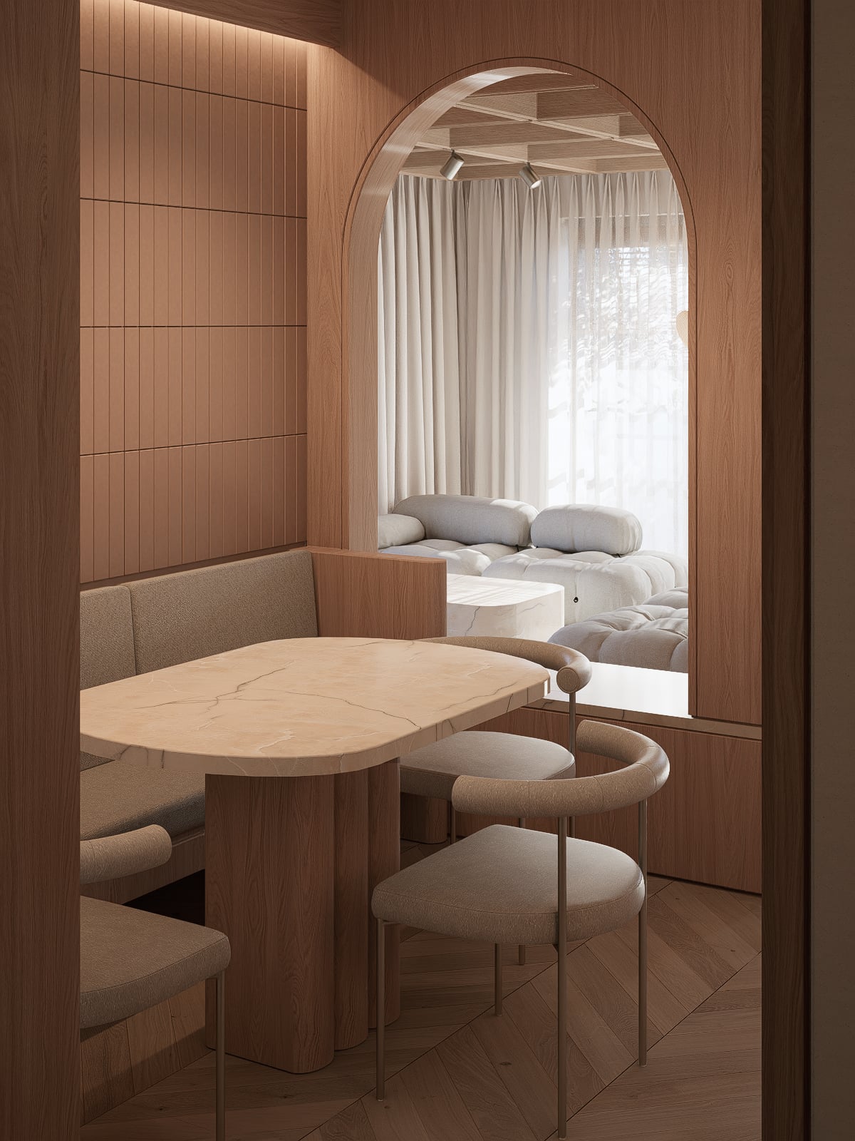 Dining nook with a rounded table and curved chairs, framed by a timber arch with a view through to the living room.