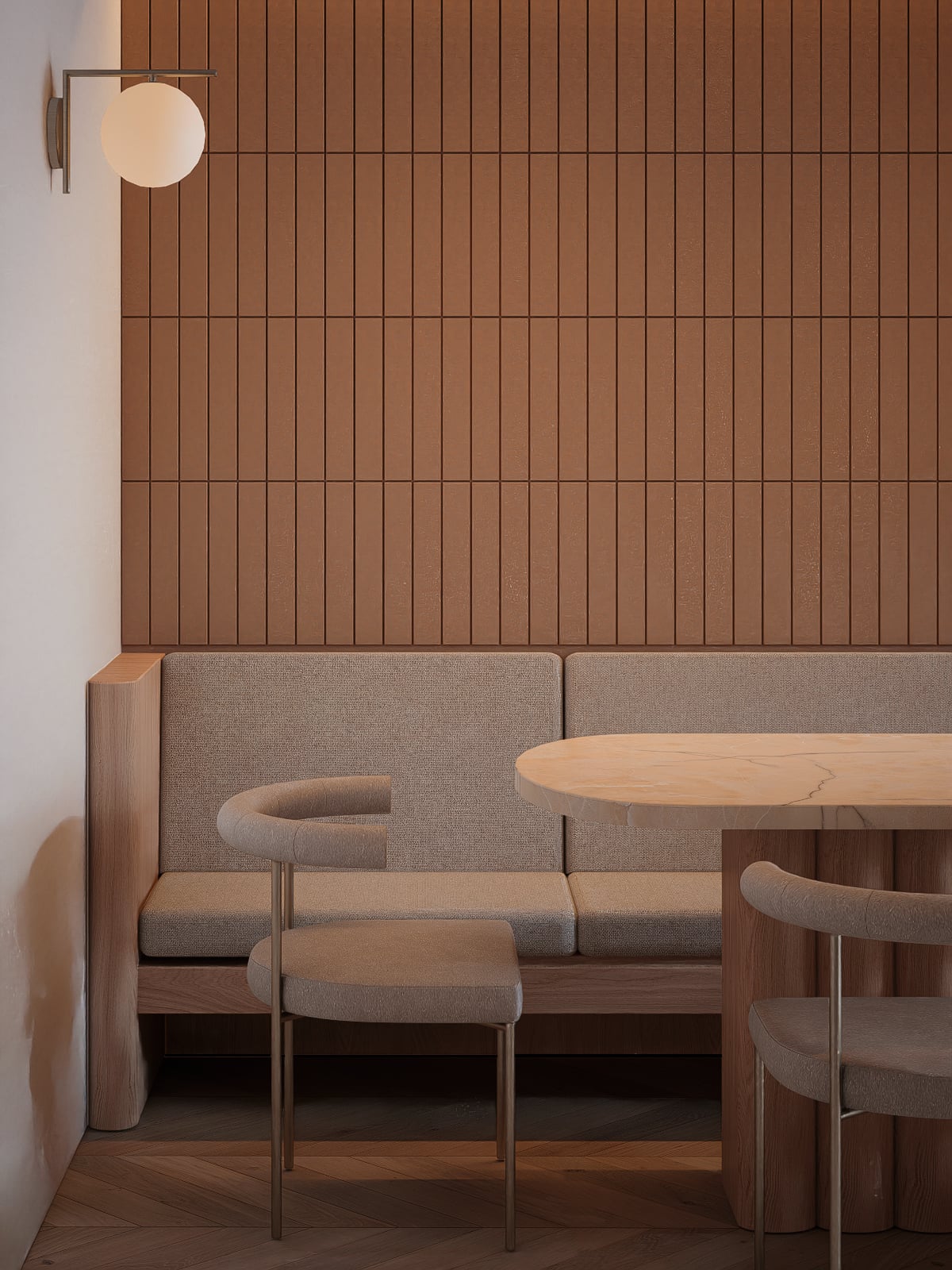 Dining with soft banquette seating against a tiled wall, and a rounded table anchoring the space.