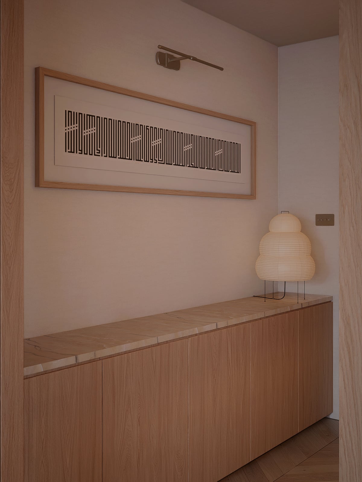 Low oak storage opposite the dining, with a framed art piece above and an Akari lamp.
