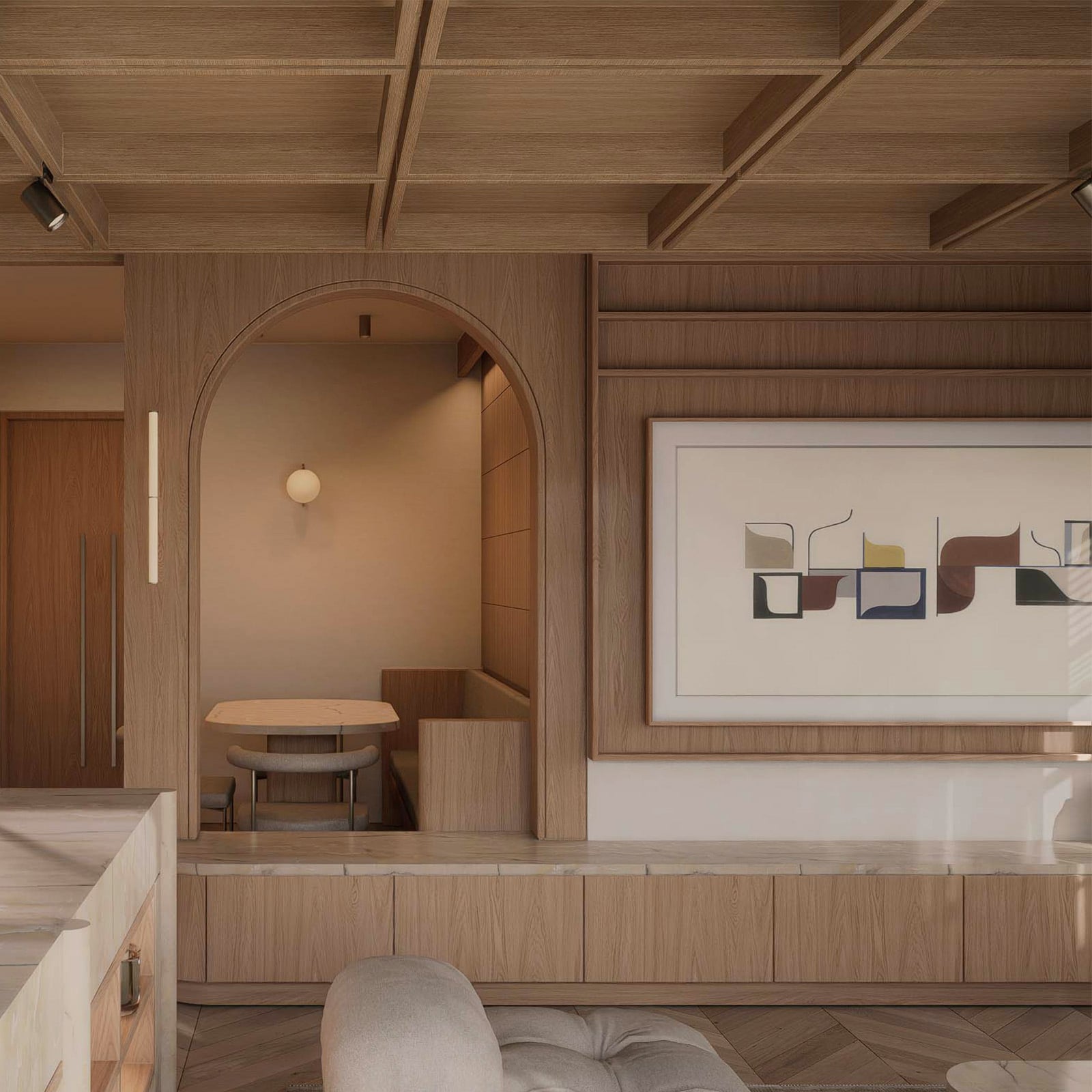 View from the kitchen through to the dining nook and living room's media wall, showing the apartment's open-plan flow.