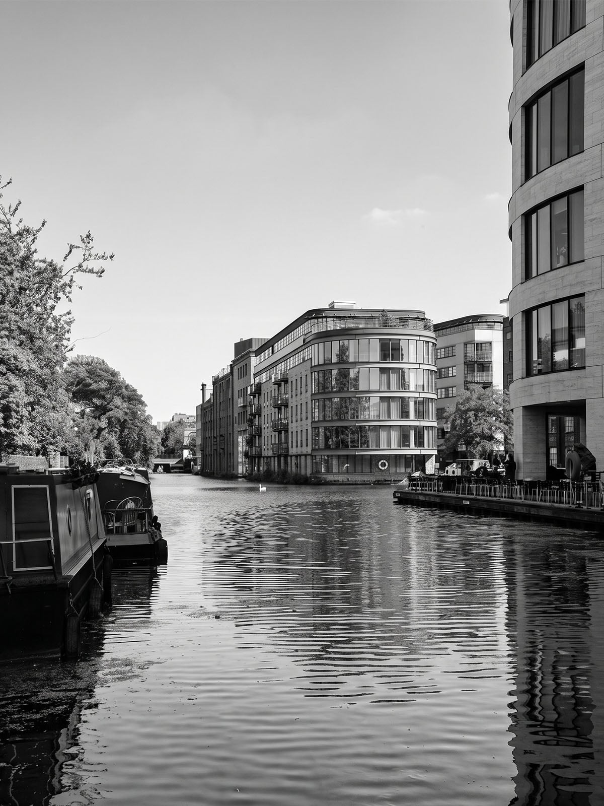 Black-and-white view of Regent's Canal and the surrounding buildings where New Wharf Residence is located.